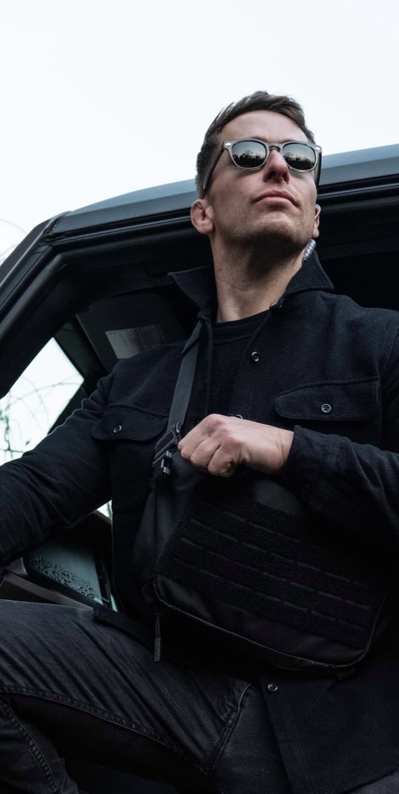 Agent exiting SUV with plate carrier